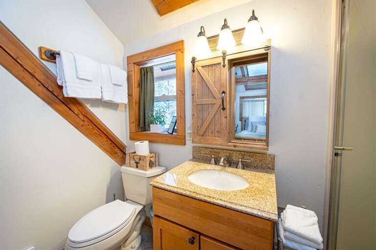 Framed by beautiful woodwork, the master bathroom is a charming rustic-inspired space | Upper Level