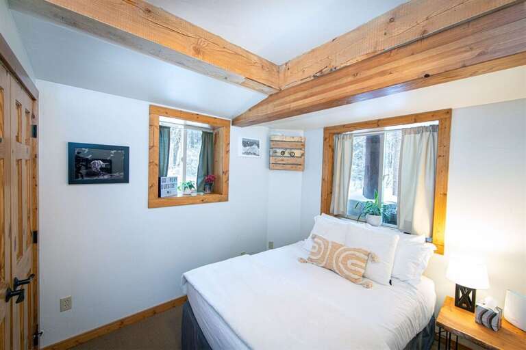 The peaceful first floor guest bedroom offers a full sized bed | Lower Level