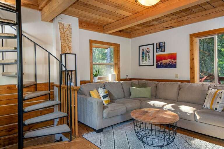 Relax and reconnect after a day of adventure in the cozy tree top living room | Main Level