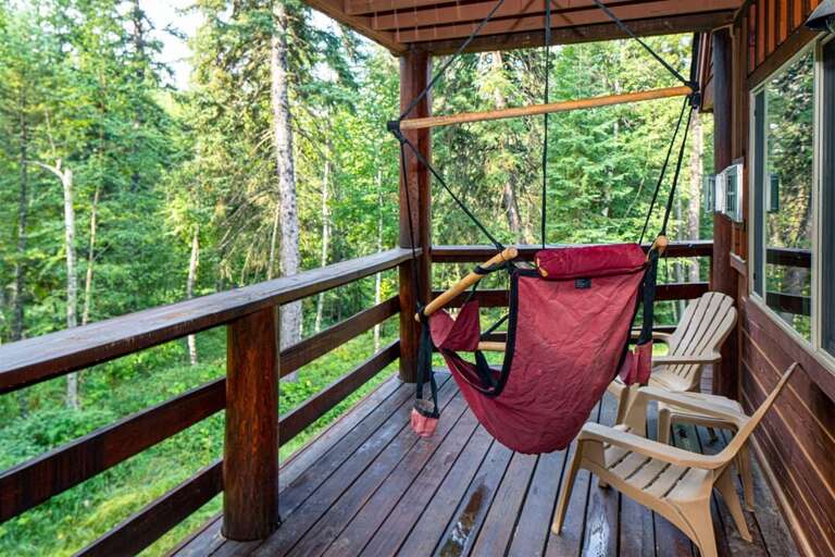 Relax and take in the woodland views from the homes wrap around deck | Exterior