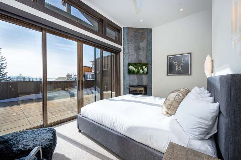 Bedroom 2 is framed by glass doors, bringing the beauty of the outdoors within | Main Level