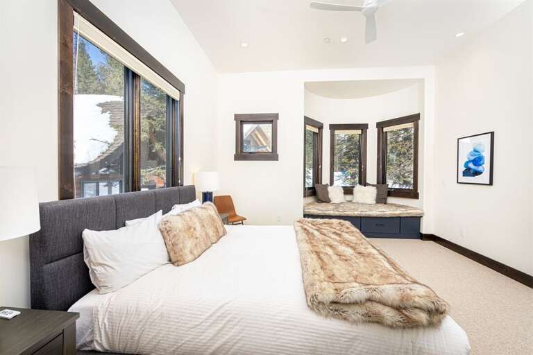 Bedroom 3 is a modern, comfortable space with king bed, walk-in closet, window seat & adjoining ensuite | Main Level