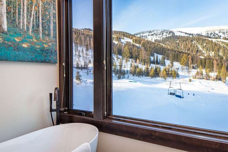 Relax in the oversized soaker tub in the master bathroom & take in view of Whitefish Mountain Resort | Main Level