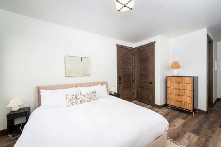 Bedroom 3 offers a king-size bed, private television, patio with bistro seating & private ensuite | Main Level