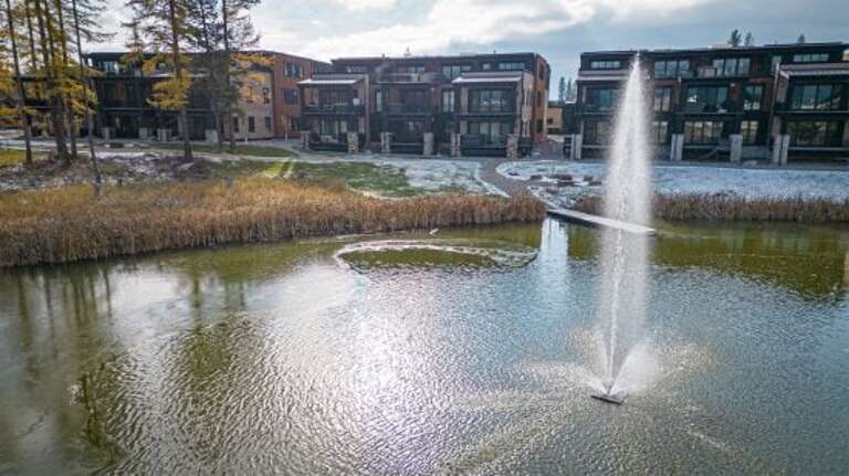 The community pond provides a peaceful setting to take in the scenic views | Exterior