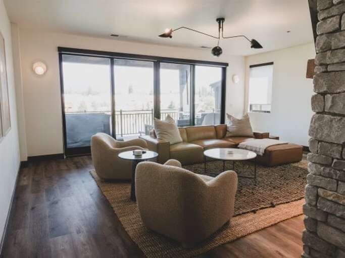 The cozy living room features modern decor and a flatscreen smart TV | Main Level