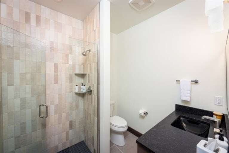 Featuring custom tile, heated floors, and high-end fixtures, the home's bathrooms provide a spa-like retreat | Main Level