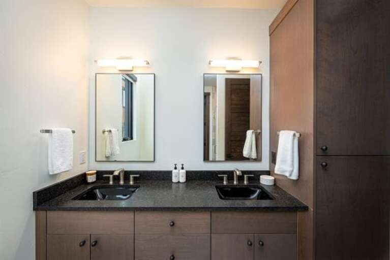 The primary bedroom ensuite has a double vanity with beautiful modern fixtures | Main Level
