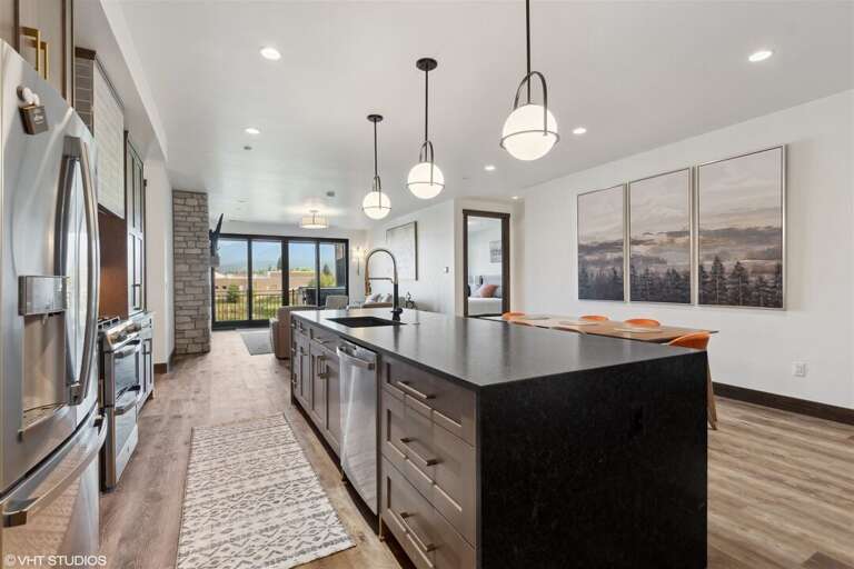 Prepare a meal without missing out on the action in this open concept living space | Main Level