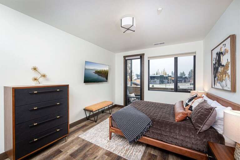 Bedroom 3 offers a queen bed, television, private patio & luxurious ensuite | Main Level