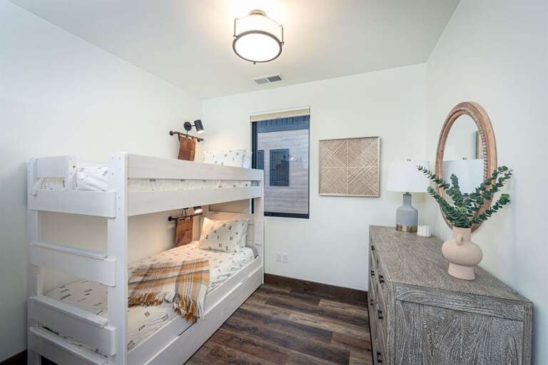 The bunk room offers 3 twin beds & a full-size sleeper sofa | Main Level