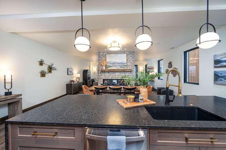 The kitchen is beautifully appointed with high-end fixtures and appliances | Main Level