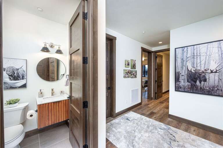 The main hallway leads toward the two king suites and queen suite | Main Level