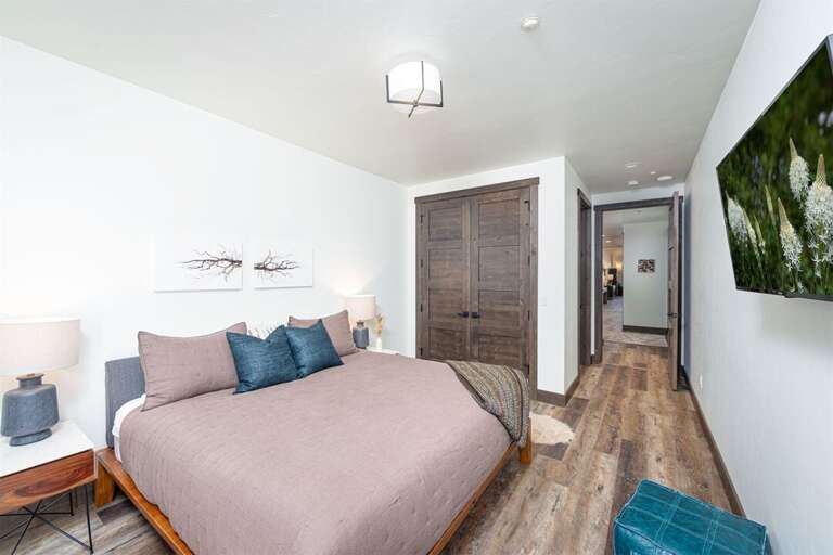 Relax in the comfortable king suite with a private balcony and television | Main Level