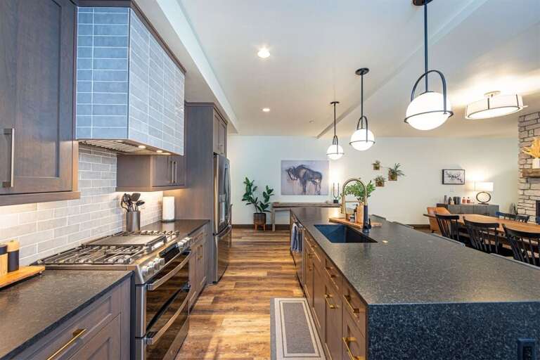 Thoughtfully designed, the kitchen overlooks the dining area and pass-through fireplace | Main Level