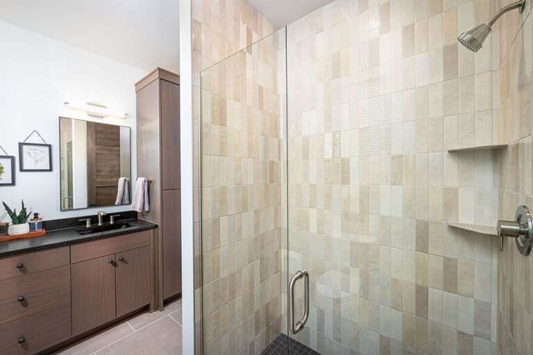 The walk-in custom tile shower is a spa-like oasis | Main Level