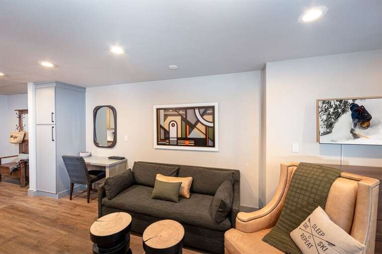 The cozy living area offers a queen sleeper sofa to accommodate additional guests | Main Level