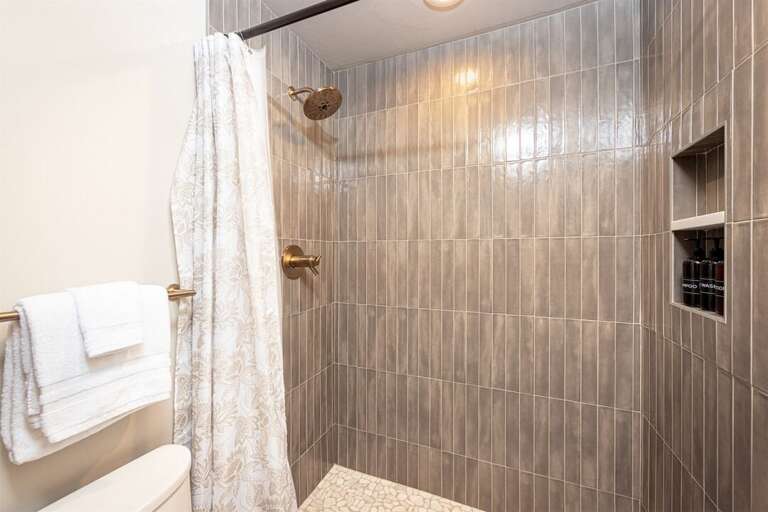 The custom tile shower provides a spa-like retreat after a day on the mountain | Main Level