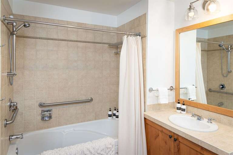 Bathroom 3 serves the main living area as well as the bunk room. This also houses the home's laundry area | Main Level