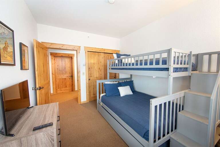 The bunk room sleeps 4 and has a private television | Main Level