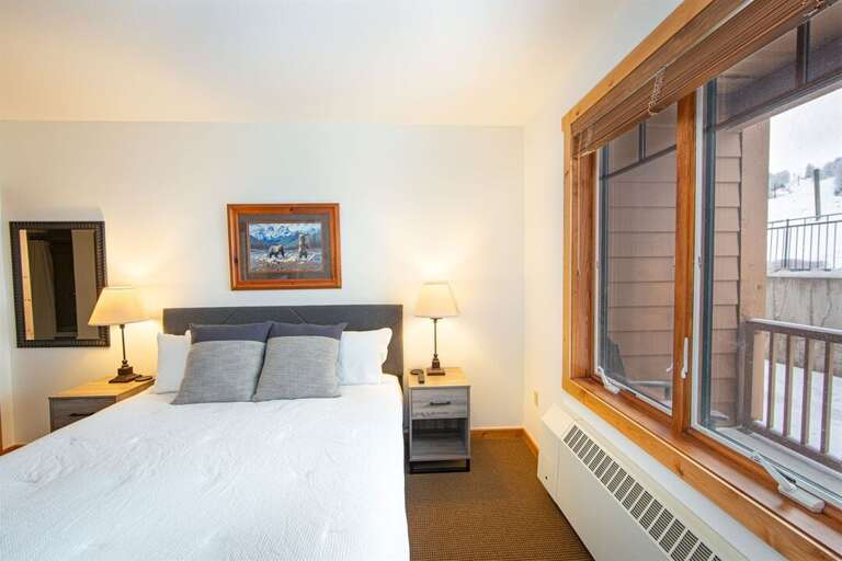 The master bedroom offers a king bed, private ensuite & television | Main Level