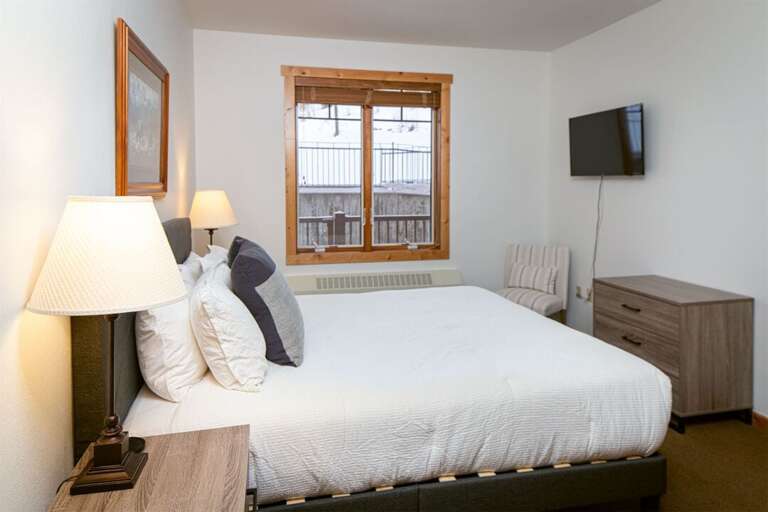 The master bedroom offers a king bed, television & private full bathroom | Main Level