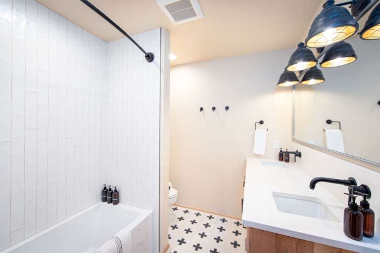 The ground floor full bathroom serves the bunk room & has beautiful modern fixtures | Basement Lowest Level