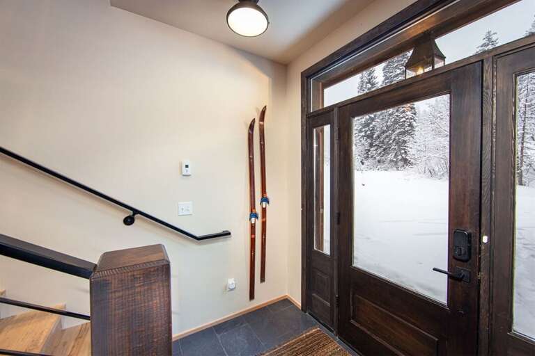 The main entryway of the home is beautifully decorated and features a built-in bench to gear up for your adventure of the day | Lower Level