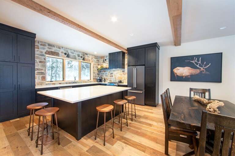 The open concept kitchen, dining & living room offers plenty of space for your whole group to gather | Middle Level