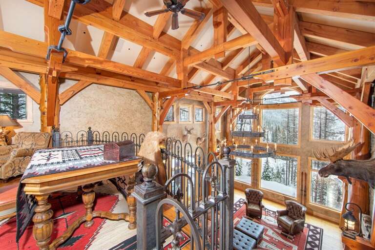 The balcony overlooking the Great Room is framed by spectacular woodwork | Upper Level