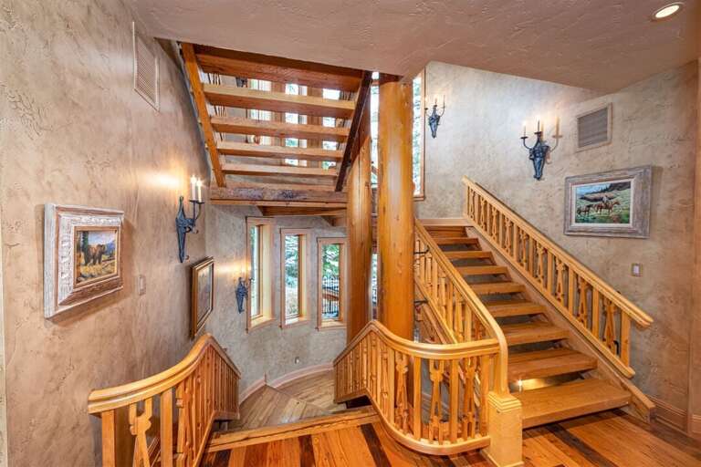 Custom woodwork embellishes the stairwells that run on both ends of the home for easy Custom