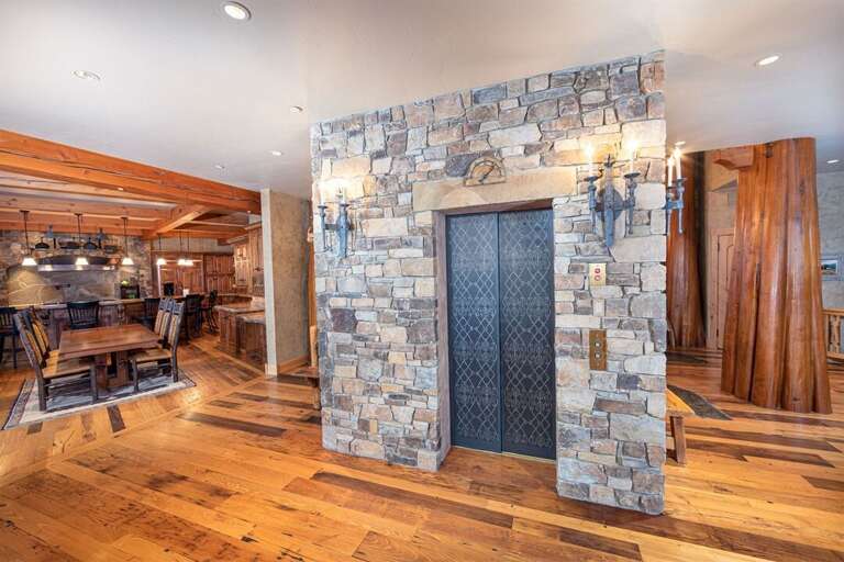 Lined with antique skis, the elevator allows for effortless access to all four floors of the home | Main Level