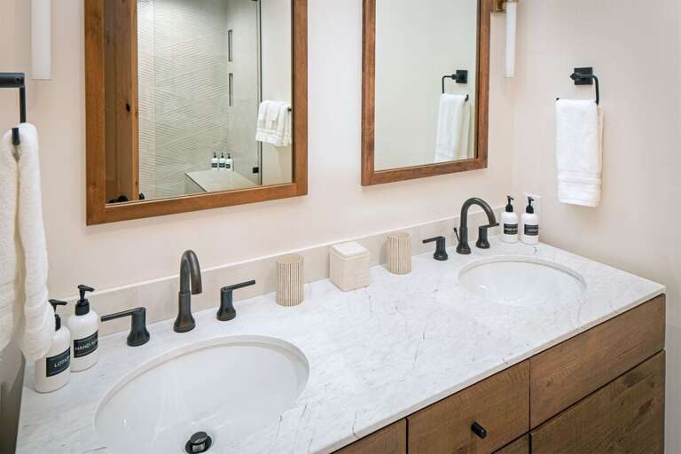 The master ensuite has a double vanity with a modern rustic esthetic | Main Level