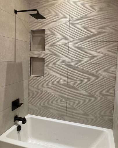 The guest bathroom offers a shower with bath tub | Main Level The guest bathroom offers a shower with bath tub | Main Level