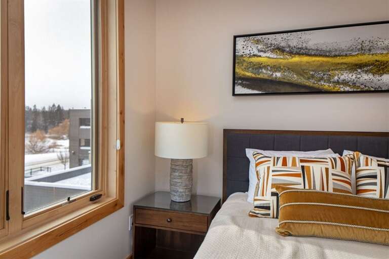 The guest bedroom has a modern-rustic esthetic with a queen bed | Main Level The guest bedroom has a modern-rustic esthetic with a queen bed | Main Level