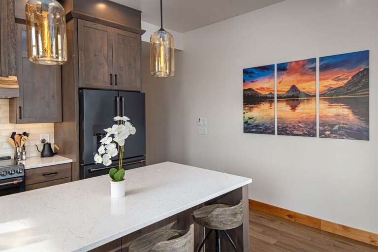 The kitchen features high-end appliances, oversized island with seating & induction range | Main Level The kitchen features high-end appliances, oversized island with seating & induction range | Main Level