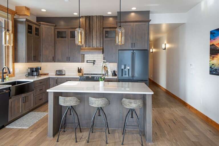 The kitchen features modern fixtures, high end appliances & island with seating | Main Level The kitchen features modern fixtures, high end appliances & island with seating | Main Level