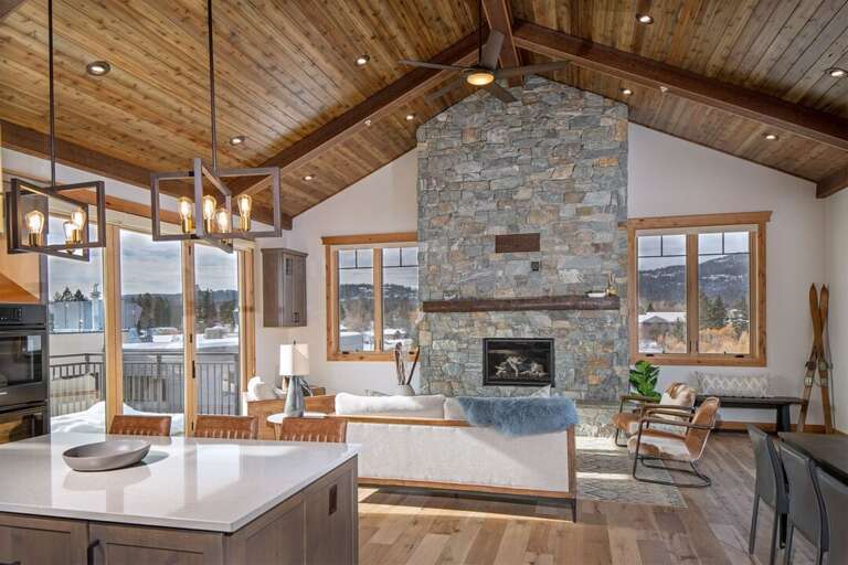 The living room features a stone gas fireplace to keep warm on chilly Montana days | Main Level