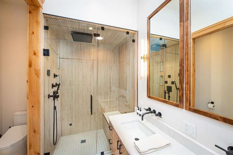 The master ensuite has custom tile & steam shower to refresh after a day of adventure | Main Level