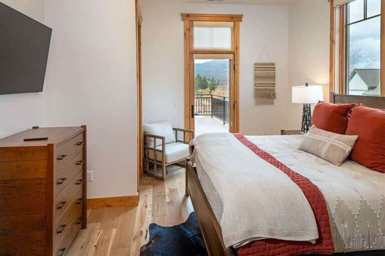 Relax & recharge in the master suite with patio access, television, walk-in closet & luxurious ensuite | Main Level