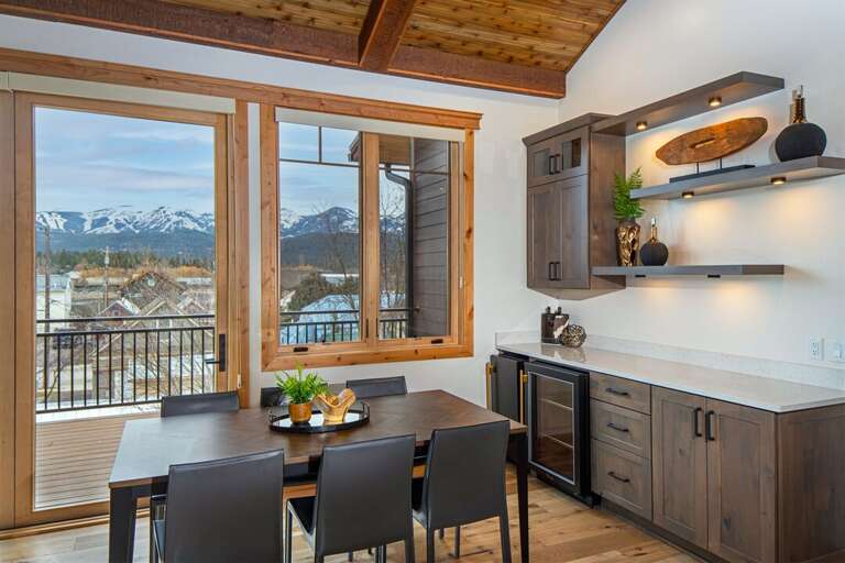 The tastefully decorated dining area features a wine bar with fridge & ice maker AND incredible mountain views | Main Level