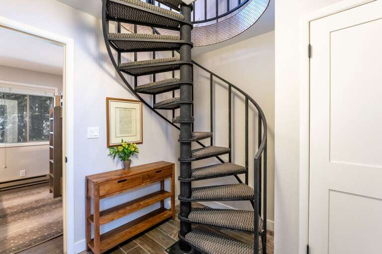 Spiral Space saver staircase  leading to the bedrooms below | Lower Level Spiral Space saver staircase  leading to the bedrooms below | Lower Level