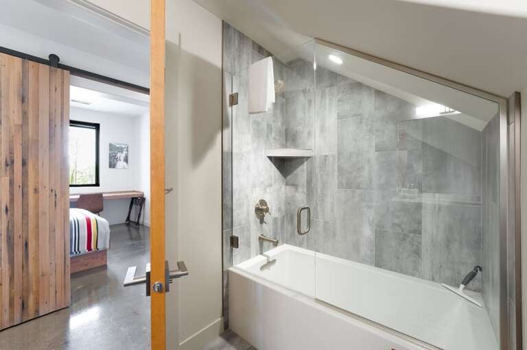 Shared bathroom with a shower/ tub combo | Lower Level