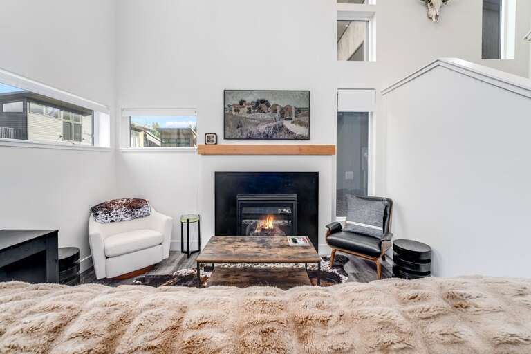 Living room with comfortable leather sofa, a cozy gas fireplace, and a Smart TV | Main Level
