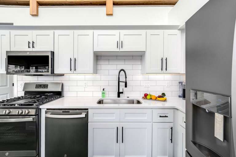 Stainless steel appliances include a gas range with a center griddle | Main Level