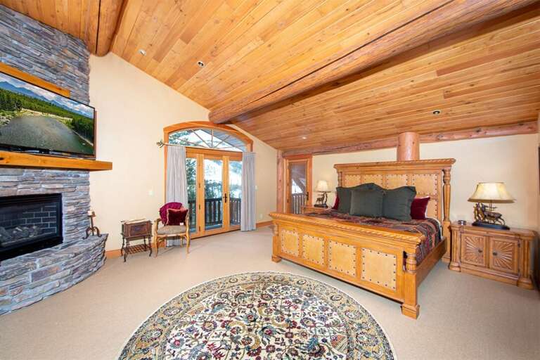 The expansive master suite with wood inlaid ceiling & two private patios, is an incredible place to relax after a day of adventure | Upper Level The expansive master suite with wood inlaid ceiling & two private patios, is an incredible place to relax after a day of adventure | Upper Level