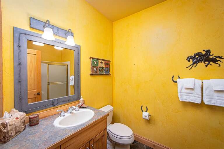 The ground floor full bathroom features charming cowboy decor | Lower Level The ground floor full bathroom features charming cowboy decor | Lower Level