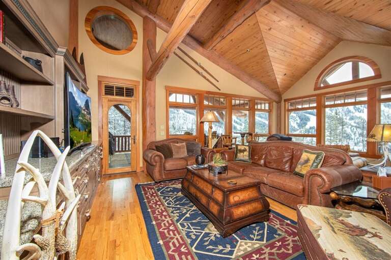 With peaked wood-inlaid ceilings and picture windows, the great room is a special gathering place in the home | Main Level With peaked wood-inlaid ceilings and picture windows, the great room is a special gathering place in the home | Main Level