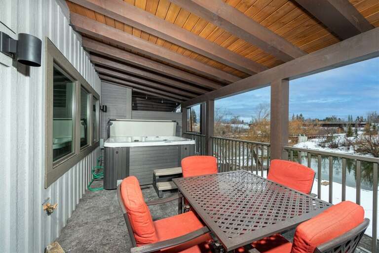 The 3rd floor patio offers seating, a private hot tub, and river views | Exterior