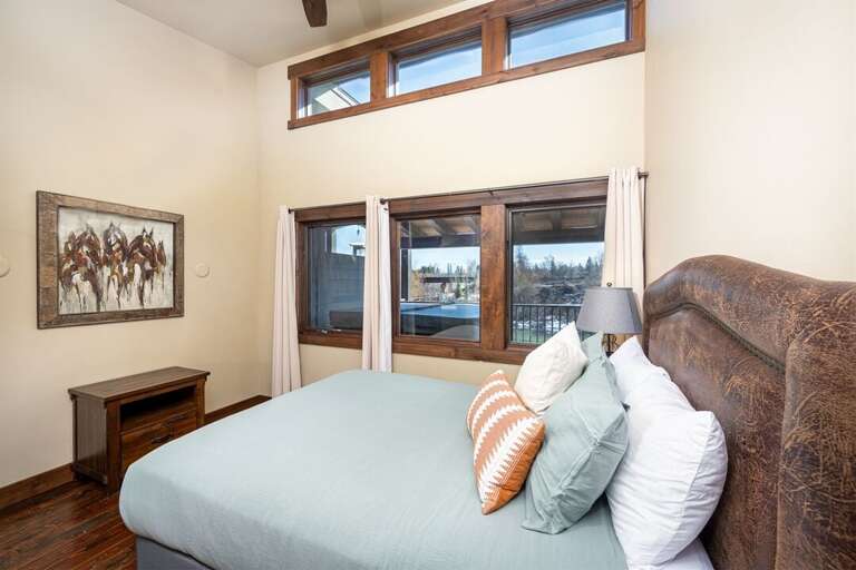 Bedroom 2 offers a queen bed that overlooks the patio and faces the Whitefish River | Upper Level